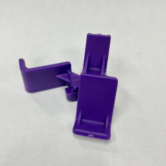 Ruff Land Kennel Clix Easy Squeeze accessory in purple, shown on kennel door